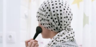 woman with cancer applies makeup - photo by Ivan Samkov from Pexels