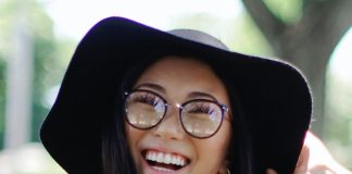 cheerful woman wearing floppy hat and glasses - photo by Leah Kelley on Pexels