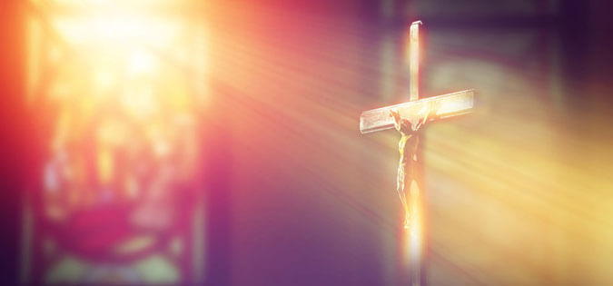 light shines on crucifix