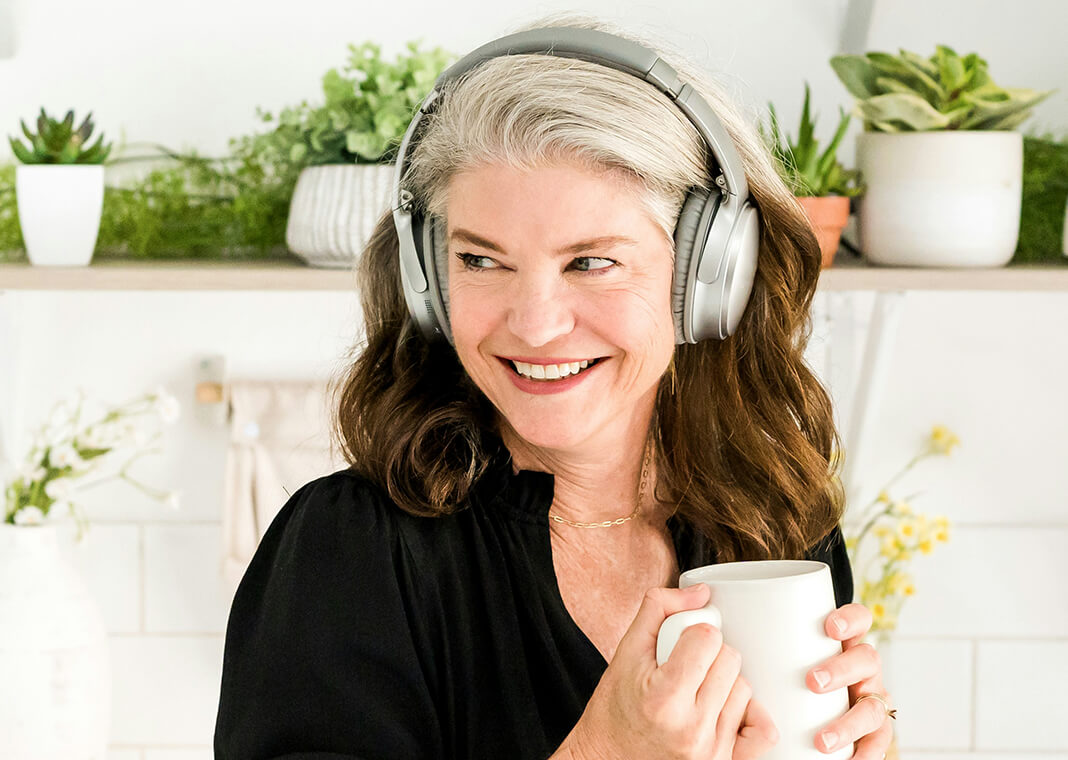 woman with headphones and coffee cup - photo by Katie Lyke on Unsplash