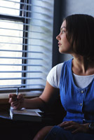 boredom in prayer - woman staring out window