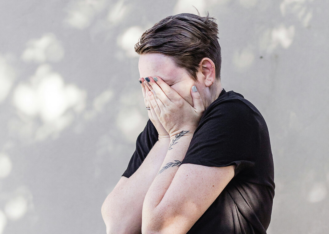 upset woman holding her hands over her face - photo by Sincerely Media on Unsplash