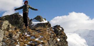 person standing on edge of mountain