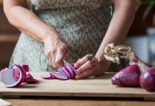 woman cutting onions - Westend61/Getty Images
