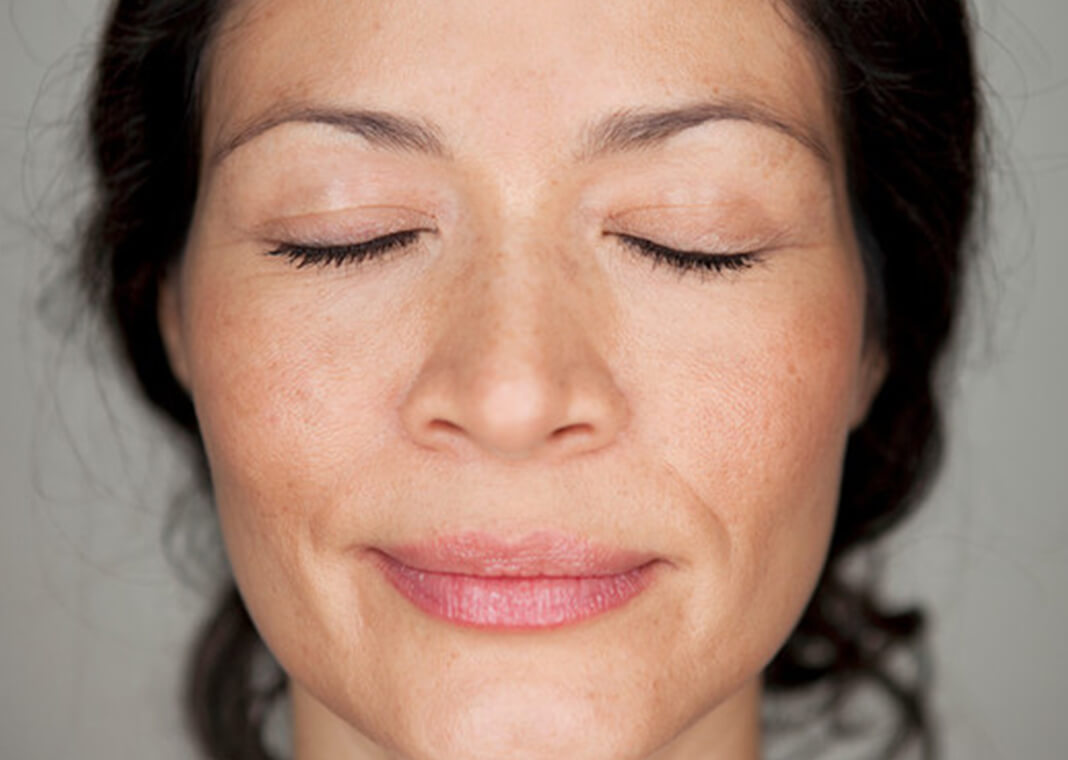 close-up face of woman in prayer