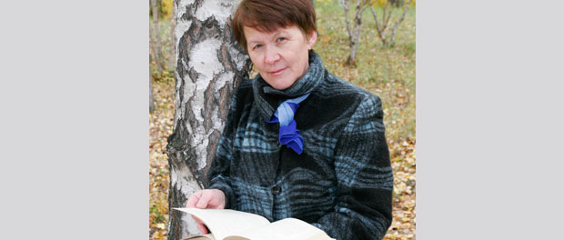 woman outdoors with book