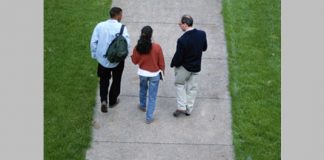 college students walking with professor