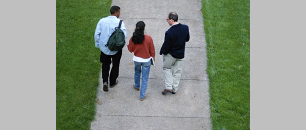 college students walking with professor