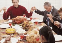 family praying around holiday table