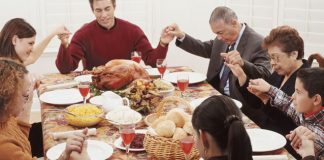 family praying around holiday table