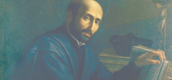 St. Ignatius Loyola sitting at his desk