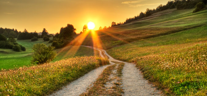 sun shining on journey down the road