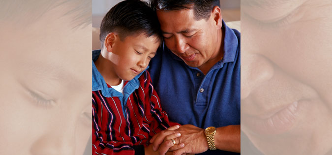 father and son praying together