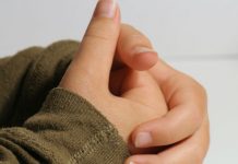 close-up on boy's hands in prayer