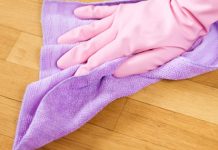 gloved hand cleaning house