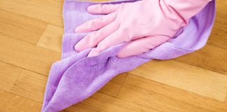 gloved hand cleaning house