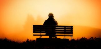 man on bench at winter sunset