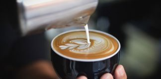 barista pouring coffee