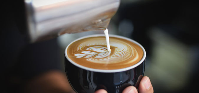 barista pouring coffee