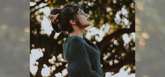 woman breathing fresh air - photo by Caique Silva on Unsplash