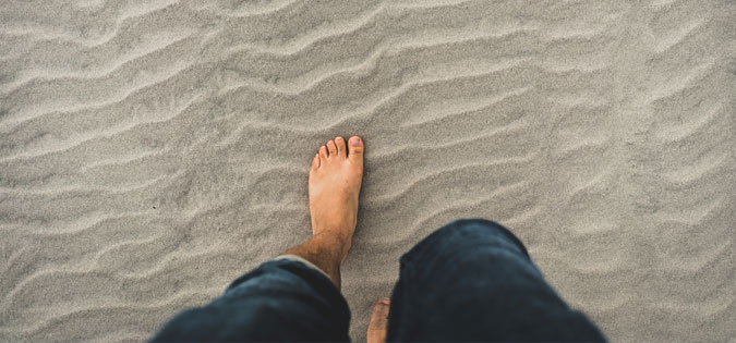 barefoot on beach - photo by Clint McKoy on Unsplash