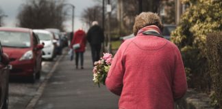 woman walking with flowers