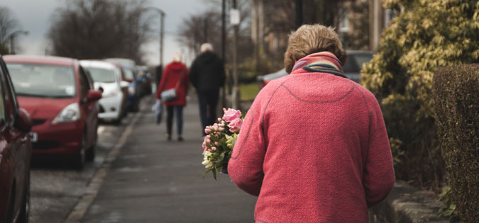 woman walking with flowers