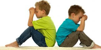 boys sitting in silent prayer