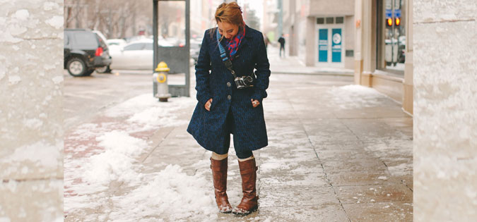 young woman looking down at snow