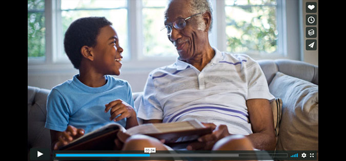 screenshot of elderly man with grandchild sharing a memory