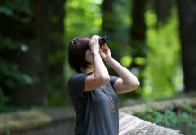 woman using binoculars - photo by Kayla Farmer on Unsplash