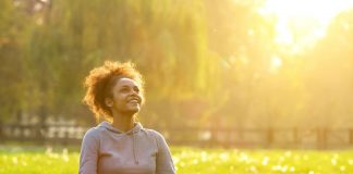 woman sitting outdoors beholding the light