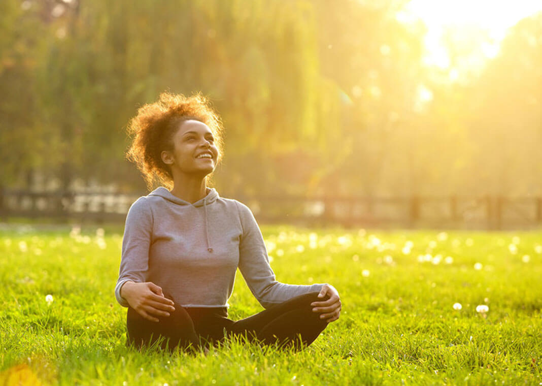 woman sitting outdoors beholding the light