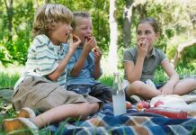 children eating outside as friends