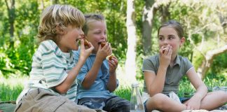 children eating outside as friends