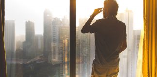 man looking over city - photo by Ishan @seefromthesky on Unsplash