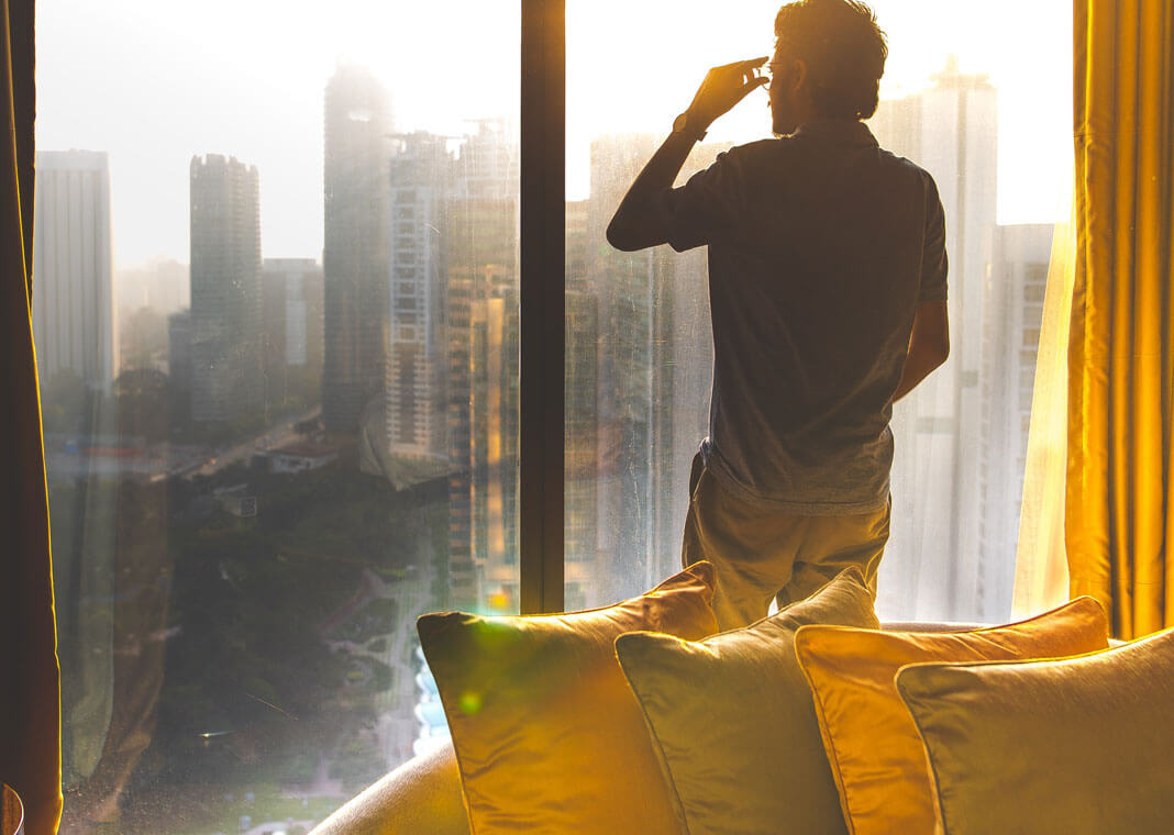 man looking over city - photo by Ishan @seefromthesky on Unsplash