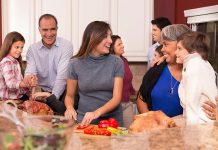 family in kitchen preparing Thanksgiving meal