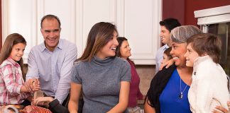 family in kitchen preparing Thanksgiving meal