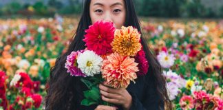 woman with flowers - photo by Remi Yuan on Unsplash