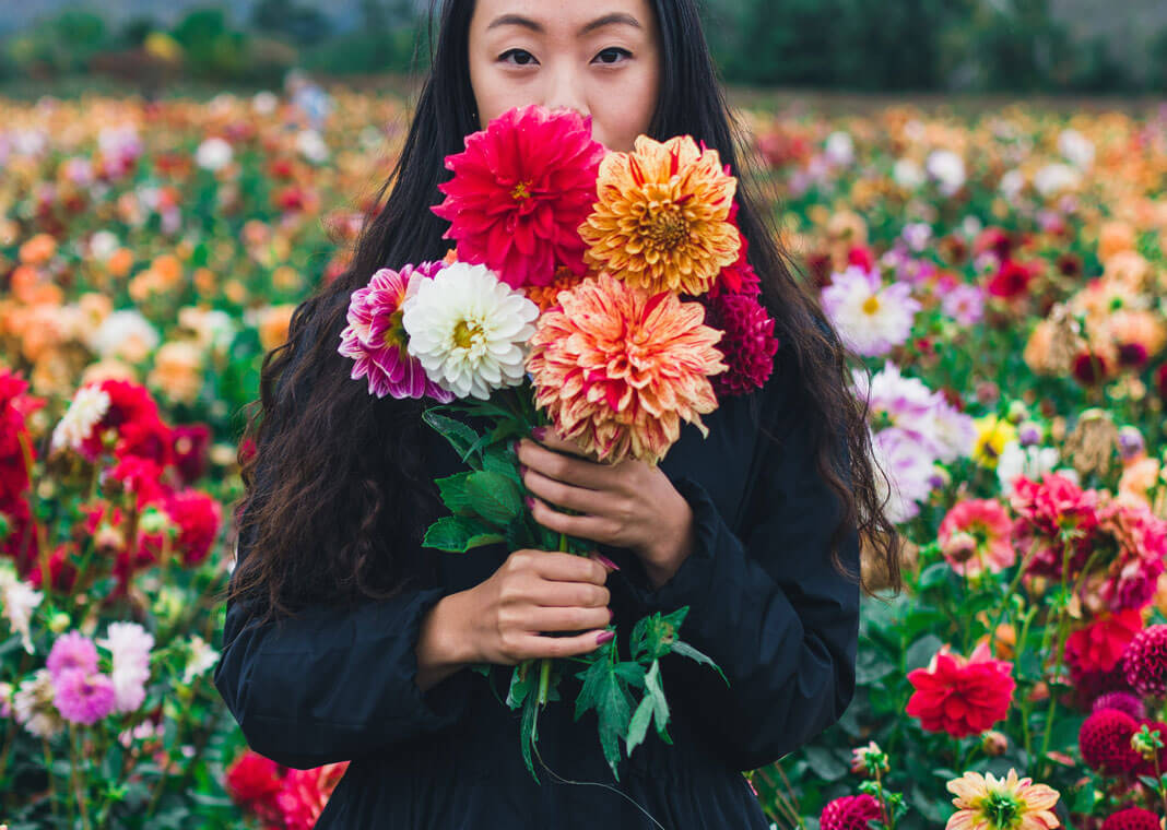woman with flowers - photo by Remi Yuan on Unsplash