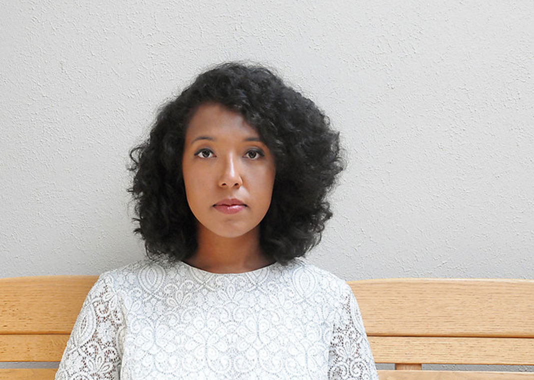 woman waiting while sitting on bench