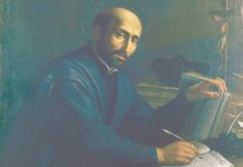 St. Ignatius sitting at his desk, writing