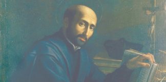 St. Ignatius sitting at his desk, writing