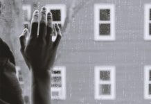 hand on rainy window - photo by Kristina Tripkovic on Unsplash
