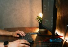 man with two computer screens - photo by Guillaume Issaly on Unsplash