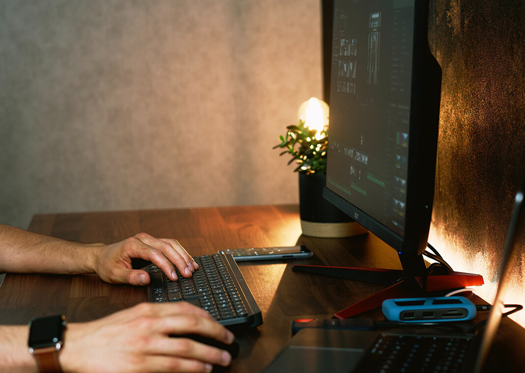 man with two computer screens - photo by Guillaume Issaly on Unsplash