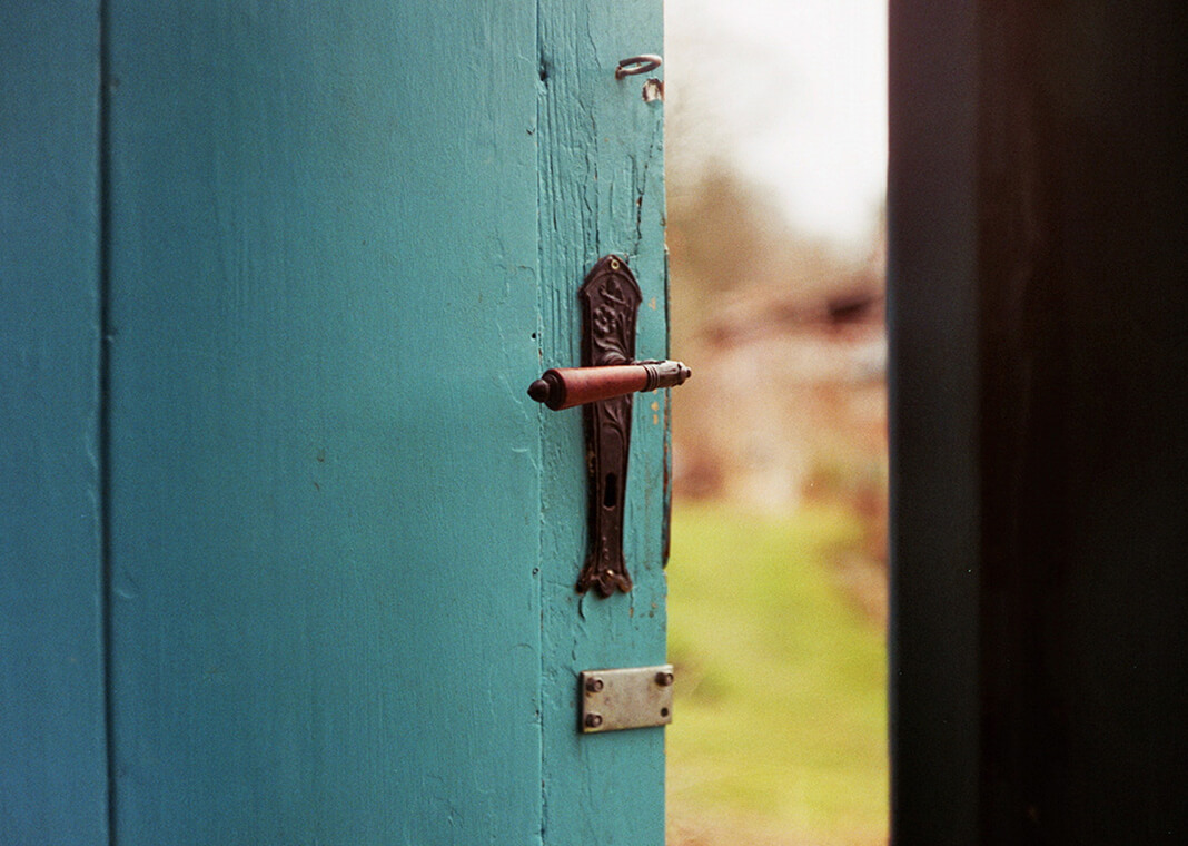 blue open door - photo by Jan Tinneberg on Unsplash