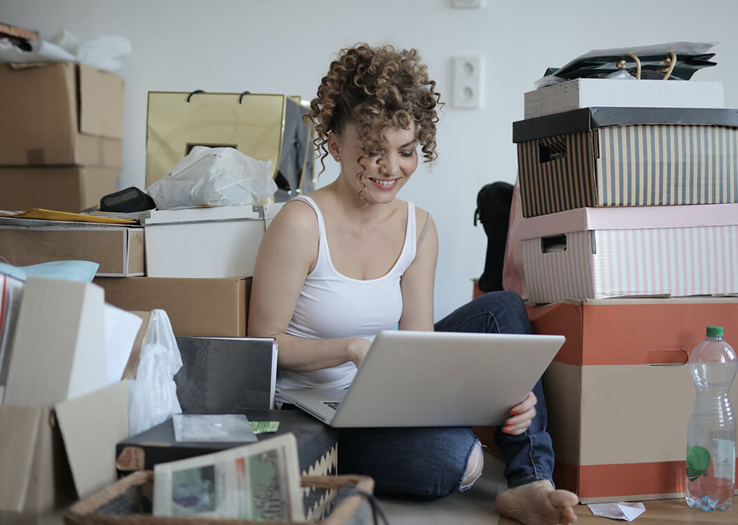 young woman surrounded by boxes - photo by Andrea Piacquadio from Pexels