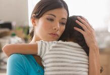 sad mother comforts child - photo by Jose Luis Pelaez Inc/DigitalVision/Getty Images